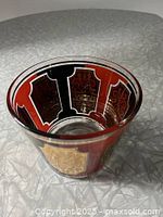 Top-down view of the ice bucket showing the inner red and black panel pattern with gold gilt detailing.
