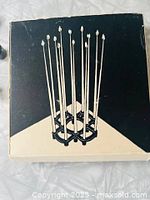 Top view photo of the original box showing an illustration of the candelabra holding twelve tall thin taper candles.