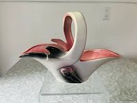 Side and angled view of vintage Hull Pottery ceramic basket with pink and parchment grey glaze showing handle and basket body.