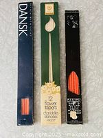 Three boxes of taper candles, each showing branding and candle color/type. Boxes worn, vintage condition.