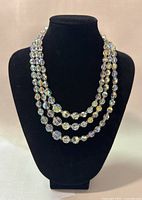 Front view of three strand faceted bead necklace with Northern Lights finish displayed on black bust.