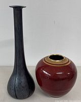 Both vases shown side by side on a neutral surface and background, showing height and shape comparison