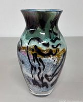 Front angle view showing multicolor abstract design and black brush stroke patterns