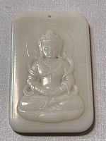 Front view showing the carved Guanyin figure with minor small dark spots on the surface and polished edges.