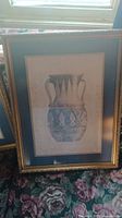 Framed art print showing double-handled ancient pottery vessel with design