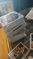Stacks of assorted basketball cards on a table featuring different players and teams.
