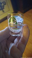 Close-up of the front side showing the gold plated rim and colorful scene of Schwetzingen on the shot glass.