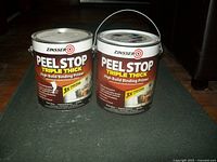 Front view of two 1-gallon cans of Zinsser Peel Stop Triple Thick High Build Binding Primer showing labels and features.