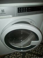 Front view of washer with door open showing control panel and drum