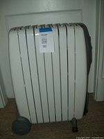 Side view showing the oil filled fins and wheels of the DeLonghi radiator