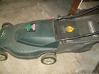 Side view of the Craftsman electric lawnmower highlighting wheels, body, and catch bag