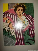 Front cover of the Picasso book showing colorful artwork of a woman in a floral headpiece and striped jacket