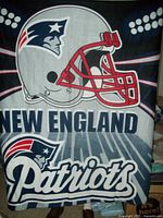 Navy blue fleece throw blanket with large Patriots helmet and logo design