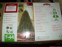 Box front showing product name, image of tree fully set up with lights, and some feature highlights