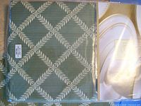 Green cloth placemat with diamond lattice and leaf pattern
