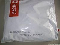 White plastic bag packaging with branding 'Classic Accessories' and slogan 'Uncover More Time Outdoors'.
