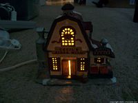 Cecil's Cider Mill ceramic light up house glowing with yellow-orange light from windows and door