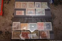 Photo showing a stock card with 11 old Ukraine mint stamps in various colors and denominations, arranged in three rows inside plastic sleeves.