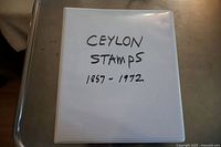 Photo of the album cover labeled 'Ceylon Stamps 1857 - 1972' showing the white binder.