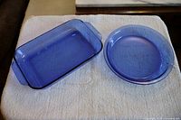 Photo of the two cobalt blue Pyrex dishes - rectangular baking pan and round pie plate shown on white towel.