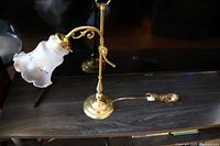 Full view of the vintage brass desk lamp showing the curved arm, brass base, and frosted glass shade with floral etching.