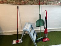 Overview of all items in lot: step ladder, broom, dustpan, vacuum cleaner, and mop