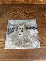 Full view of the square painting showing the dog and overall condition with wear and discoloration marks.