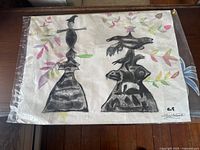 Overall view of the drawing showing both witch and crow figures with surrounding colorful leaves on paper surface.