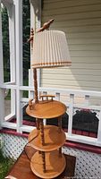 Full view of the maple wood lamp with beige pleated fabric shade, showing overall structure and appearance.