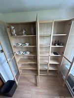 Front view of both bookcases side by side with doors open showing interior shelves and overall configuration