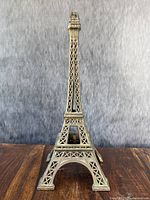 Front view of cast-metal Eiffel Tower sculpture showing base and lattice detailing