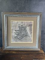 Frontal photo of the framed sterling silver artwork showing the entire piece with the soldier playing bugle horn relief and surrounding frame.