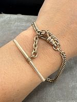 Gold-filled pocket watch chain fob bracelet worn on wrist showing T-bar and chain links.