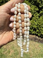 Close-up of irregular white pearls strung together