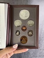 Front view of Canadian coins displayed in a protective holder featuring different designs including maritime themes and animals.