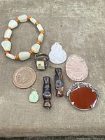 Top view of all nine antique Chinese jewelry pieces showing variety of materials and styles