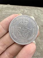 Front side of Danish 5 Kroner coin showing anniversary dates, crown, and denomination.