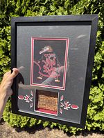 Photo of entire framed shadow box showing the Indigenous artwork on top and weaving fragment below with decorative accents around the weaving.