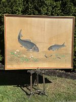 Full front view of silk painting and gilt wood frame on metal easel