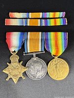 Three British World War I medals displayed together with original ribbons.