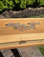 Top view showing salmon carving and painting on the cedar wood box lid.