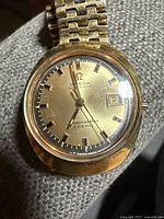 Front view of watch showing dial, hands, date window