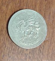 Reverse side of 1984 UK one pound coin showing the Welsh Dragon with 'ONE POUND' text beneath.