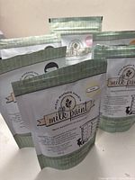 Six standing bags of Miss Mustard Seed's Milk Paint grouped together showing package fronts.