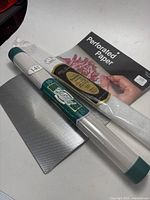 Lot contents showing the perforated paper roll, embroidery cloth roll, and Starlite fabric packet arranged on a surface.