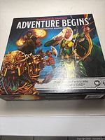 Closed box of Dungeons & Dragons Adventure Begins cooperative board game showing box art with fantasy characters.