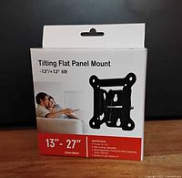 Front of the box displaying the product name, size compatibility 13-27 inches, tilting angle ±12°, a graphic of the mount, and usage image.