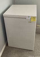 White Coldspot chest freezer with note showing dimensions L:59cm, W:57cm, H:87cm.