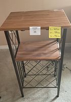 Front view of rustic two-tier wooden table with metal frame, showing dimensions and structure.