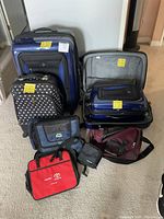 All eight luggage and bags arranged on floor to show full lot